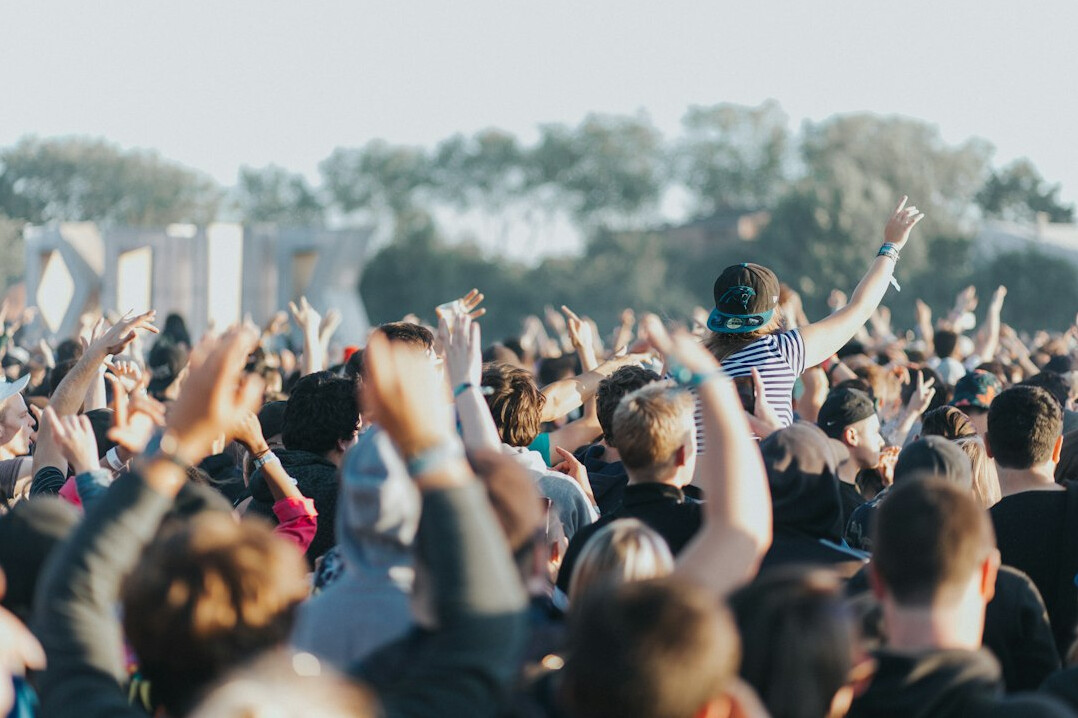 Crowd at a music festival with raised hands