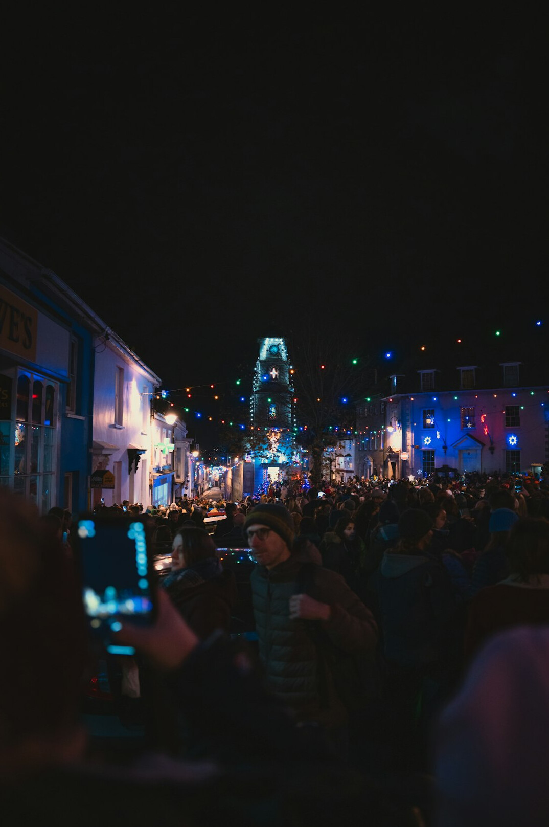 Festival crowd at night with colorful lights